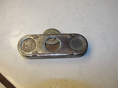 The J.E. Mergott Co token holder, metal, spring activated, Duluth 