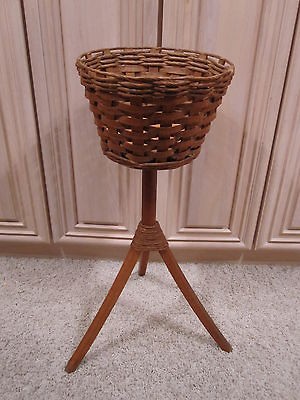 Vintage brown wicker woven basket plant stand with 3 leg pedestal