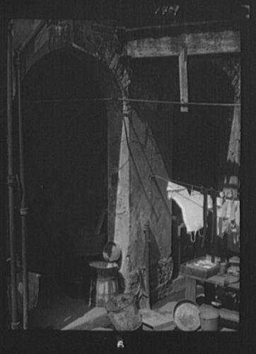   Courtyard with hanging laundry & laundry equipment, New Orleans A819