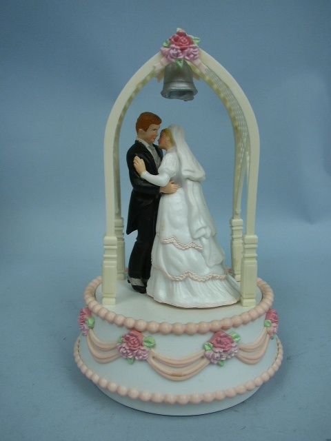   stock 555800 bride and groom in arbor musical cake topper by enesco