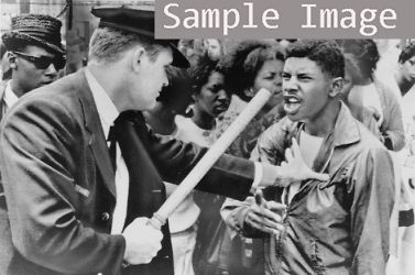 1964 Nashville police officer wielding nightstick holds African